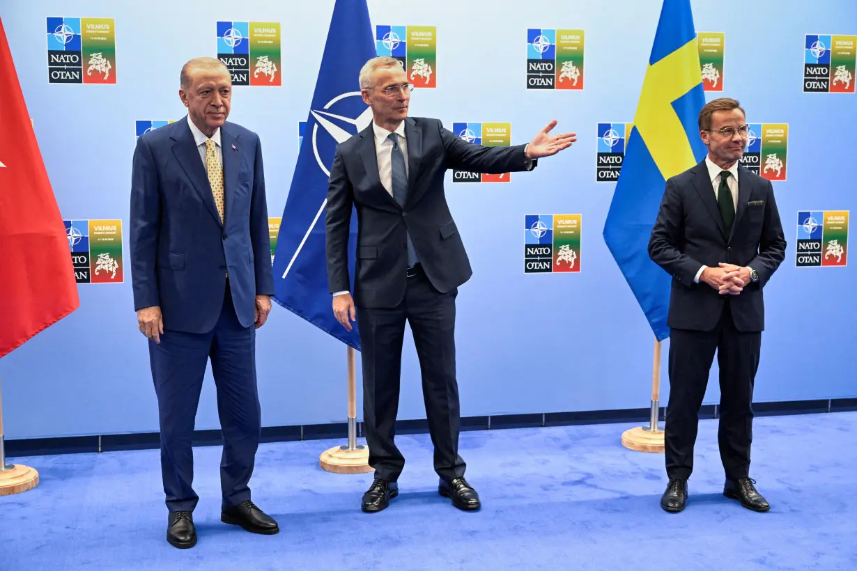 FILE PHOTO: Turkish President Erdogan and Swedish Prime Minister Kristersson shake hands next to NATO Secretary-General Stoltenberg prior to their meeting, in Vilnius