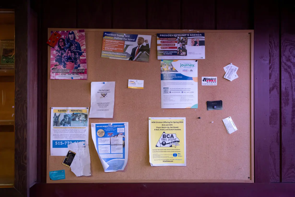 Campaign flyers of Republican presidential candidate and former U.S. President Donald Trump are seen on a message board at a billiard hall ahead of the Iowa caucus vote, in Ankeny