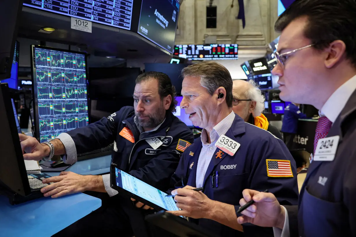 Traders work on the floor of the NYSE in New York