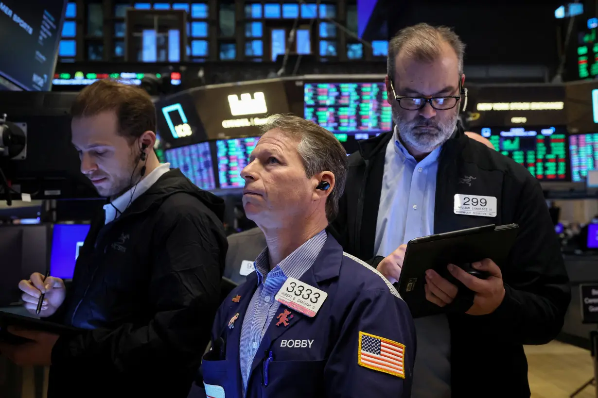 Traders work on the floor of the NYSE in New York