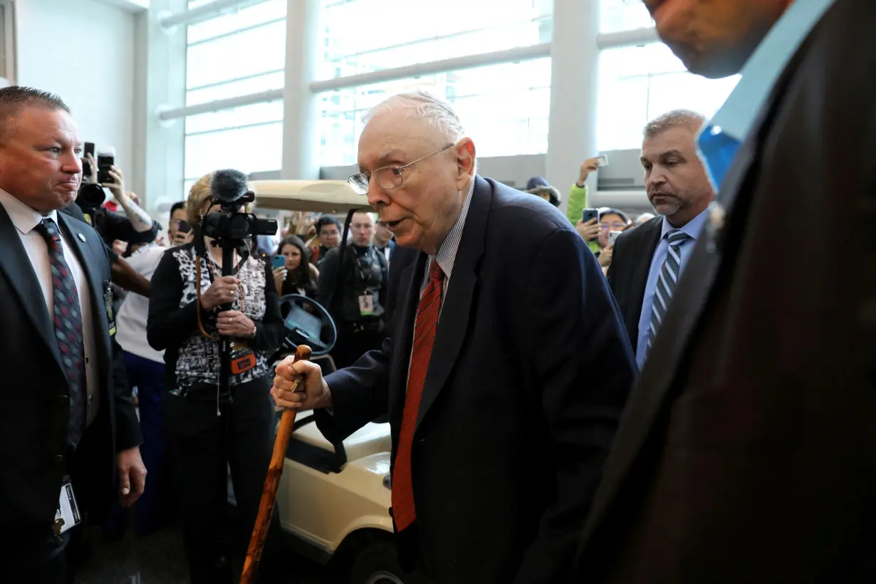 FILE PHOTO: Berkshire Hathaway Vice Chairman Charlie Munger walks past a crowd at the annual Berkshire shareholder shopping day in Omaha