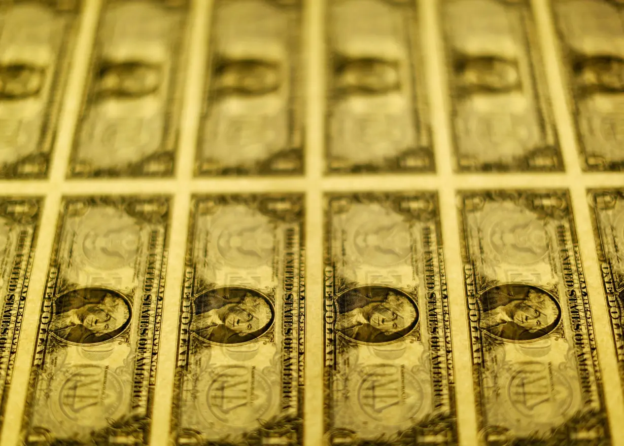 FILE PHOTO: United States one dollar bills are seen on a light table at the Bureau of Engraving and Printing in Washington