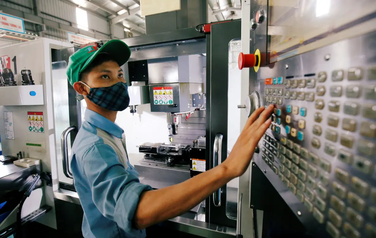 FILE PHOTO: A man works at a mechanical factory in Hanoi