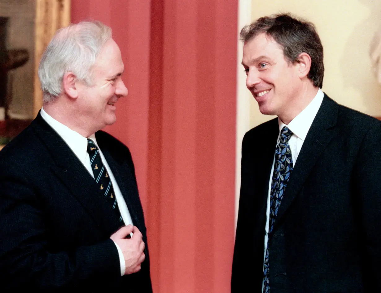 FILE PHOTO: Former Irish Prime Minister Bruton chats with Britain's Prime Minister Blair inside 10 Downing Street in London