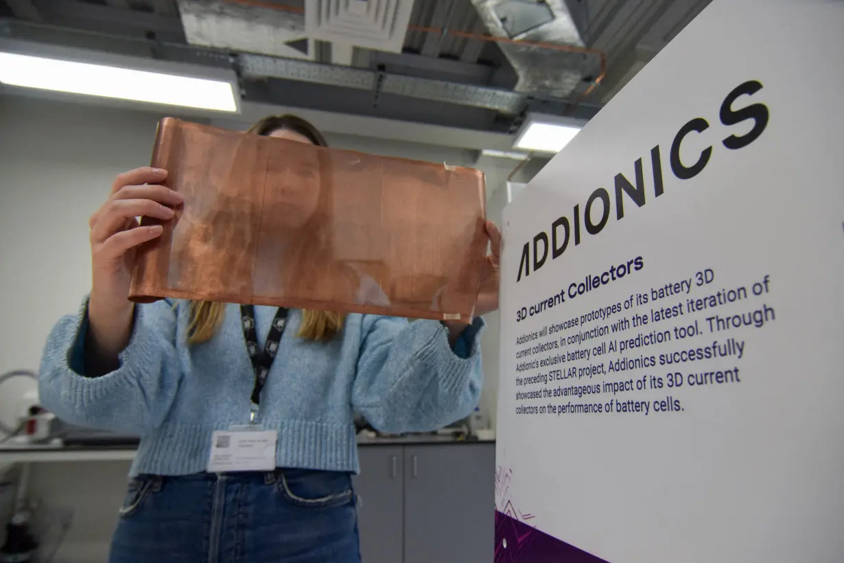 FILE PHOTO: Bernadett Vejkey, marketing manager at Addionics, holds up a sheet of a porous, three-dimensional copper anode, in London