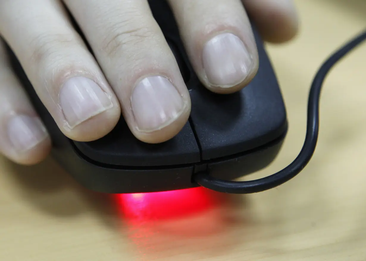 An employee uses a computer mouse inside an office in Kiev