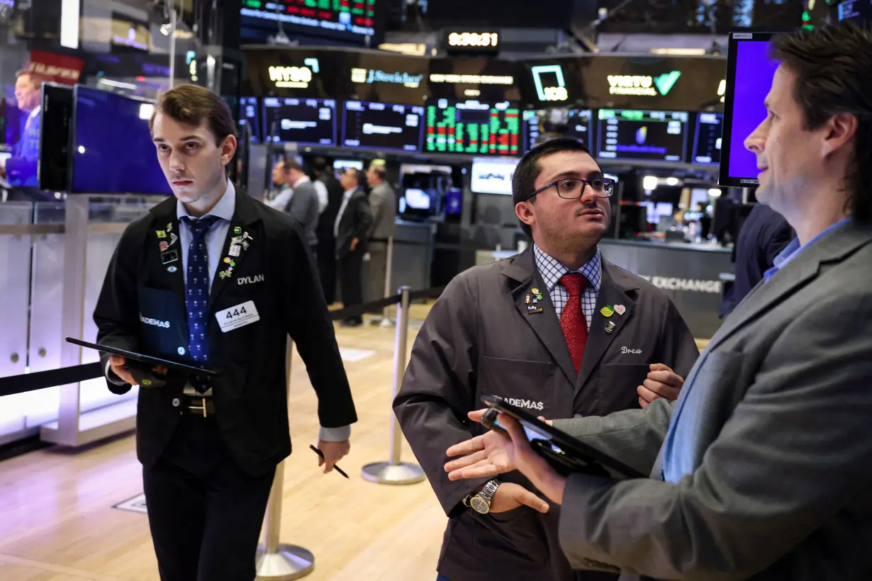 Traders work on the floor of the NYSE in New York