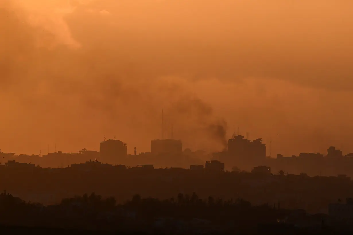 Smoke rises from Gaza, as the sun sets, amid the ongoing conflict between Israel and the Palestinian Islamist group Hamas, as seen from Sderot