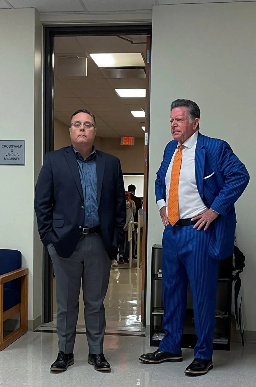 FILE PHOTO: ExxonMobil Senior VP Scott waits outside a courtroom in Conroe