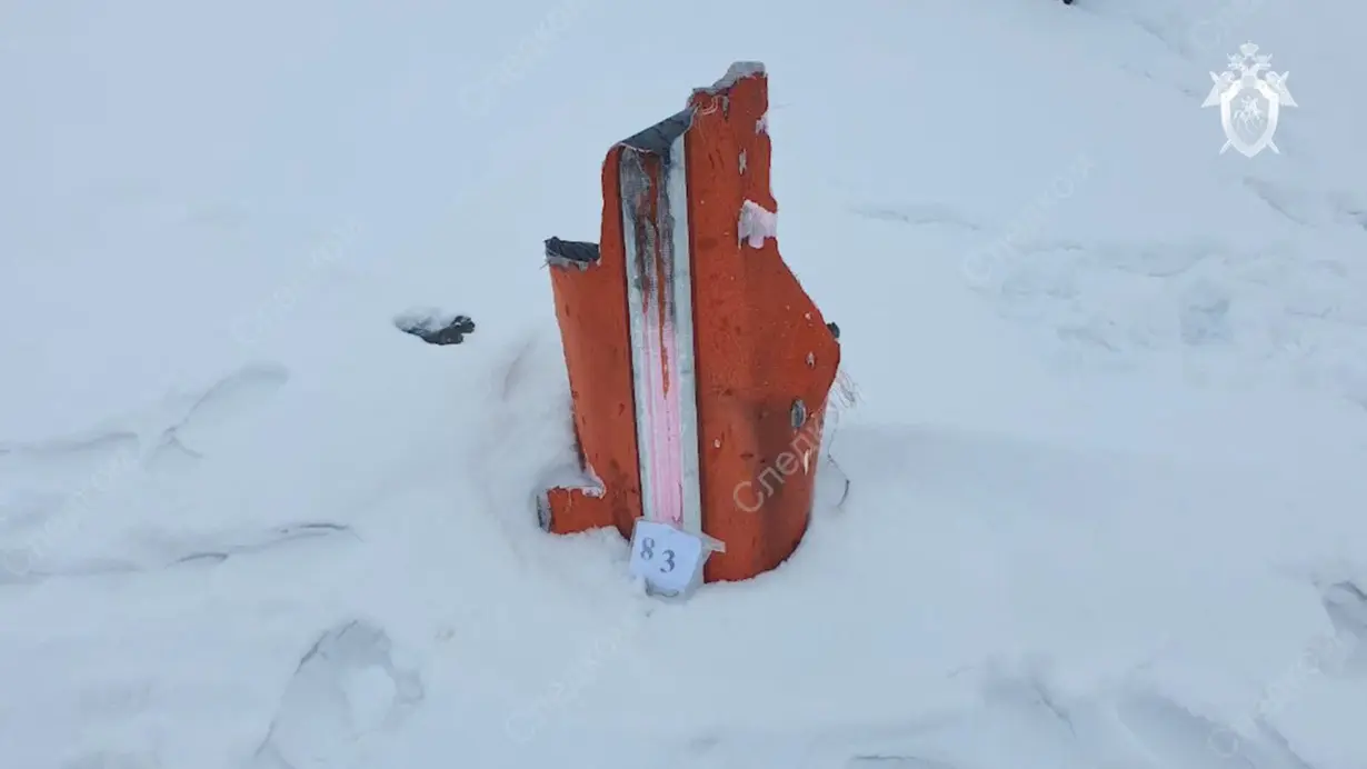 Investigators examine fragments of missiles at the crash site of Russian Il-76 military plane in Belgorod region