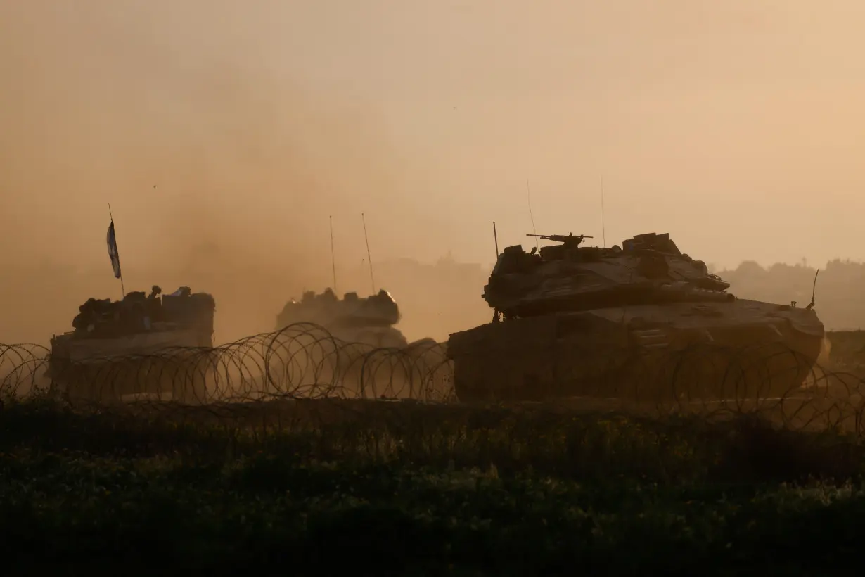 Israeli military vehicles manoeuvre on the border with southern Gaza