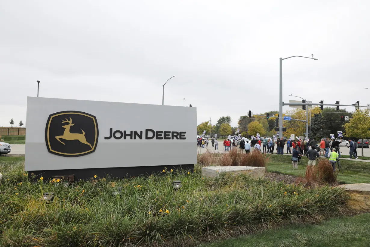 Striking members of the United Auto Workers (UAW) picket at the Deere & Co farm equipment plant before a visit by U.S. Agriculture Secretary Tom Vilsack in Ankeny, Iowa