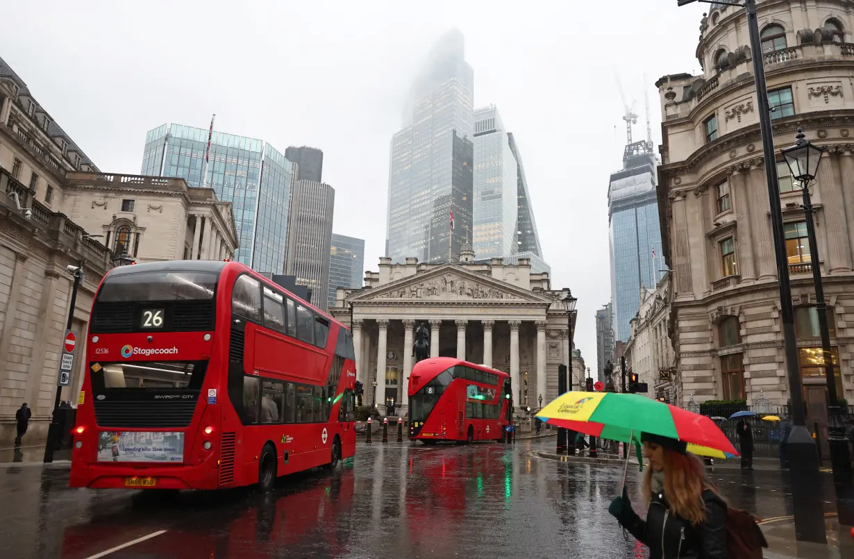 Commuters walk in City of London financial district in London