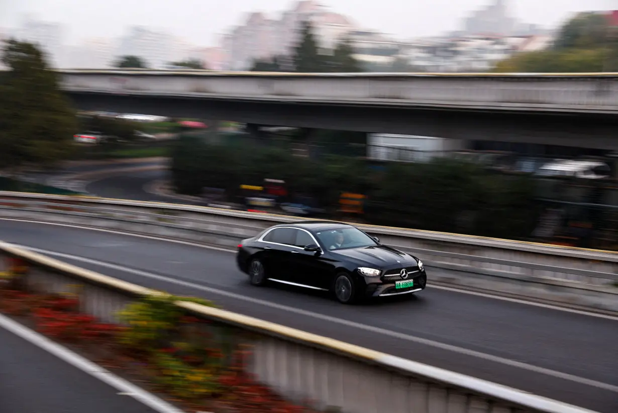 FILE PHOTO: Electric vehicle (EV) by Mercedes-Benz moves on a street in Beijing