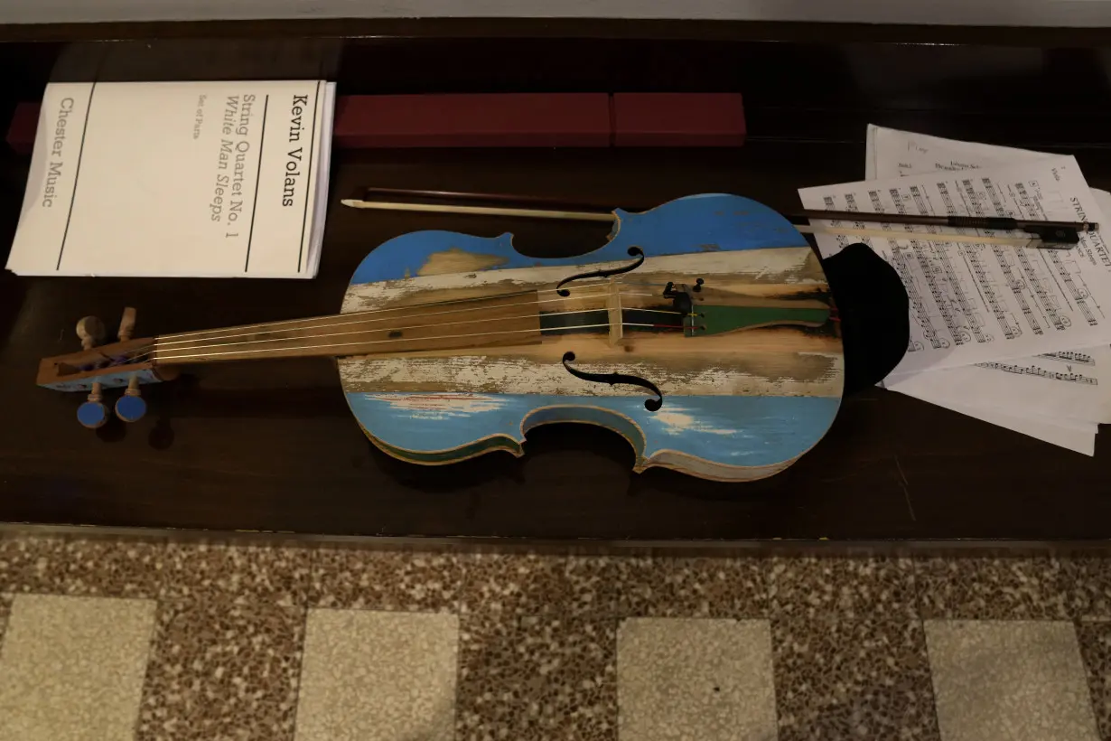 Italian inmates attend La Scala concert featuring violins they made from smugglers' boats