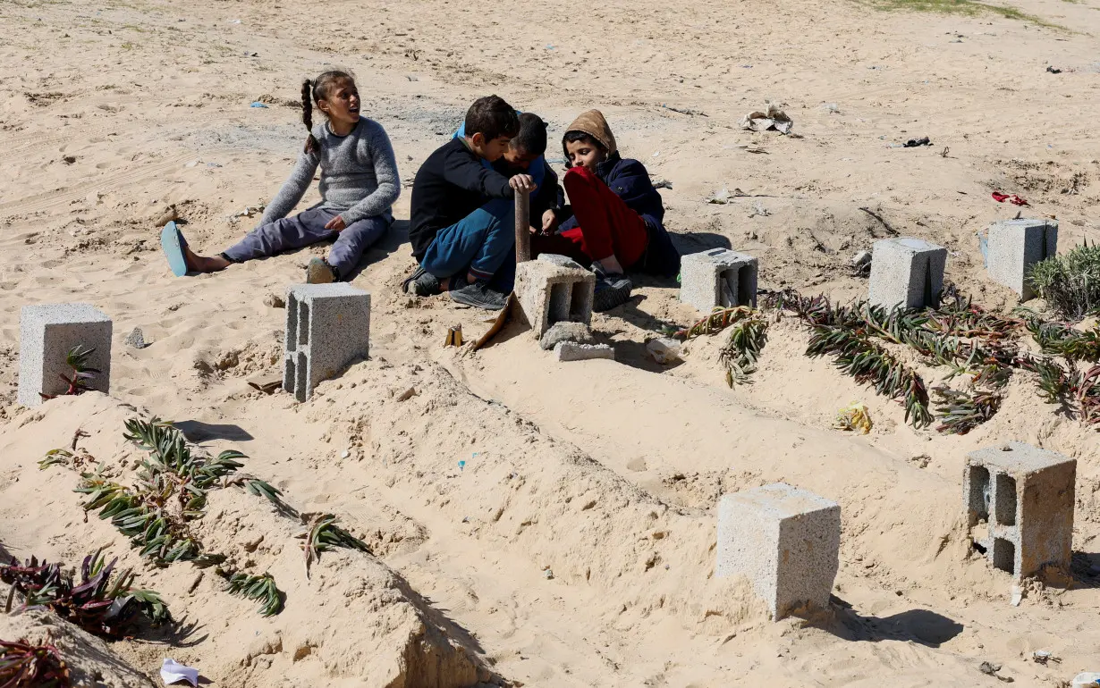 Displaced Palestinians shelter in a cemetery in Rafah in the southern Gaza Strip