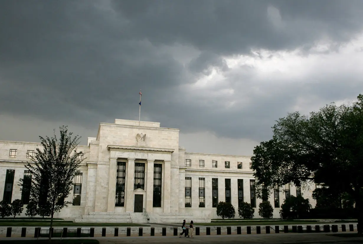 FILE PHOTO: Early summer storm clouds gather over U.S. Federal Reserve Building before evening thunderstorm in Washington