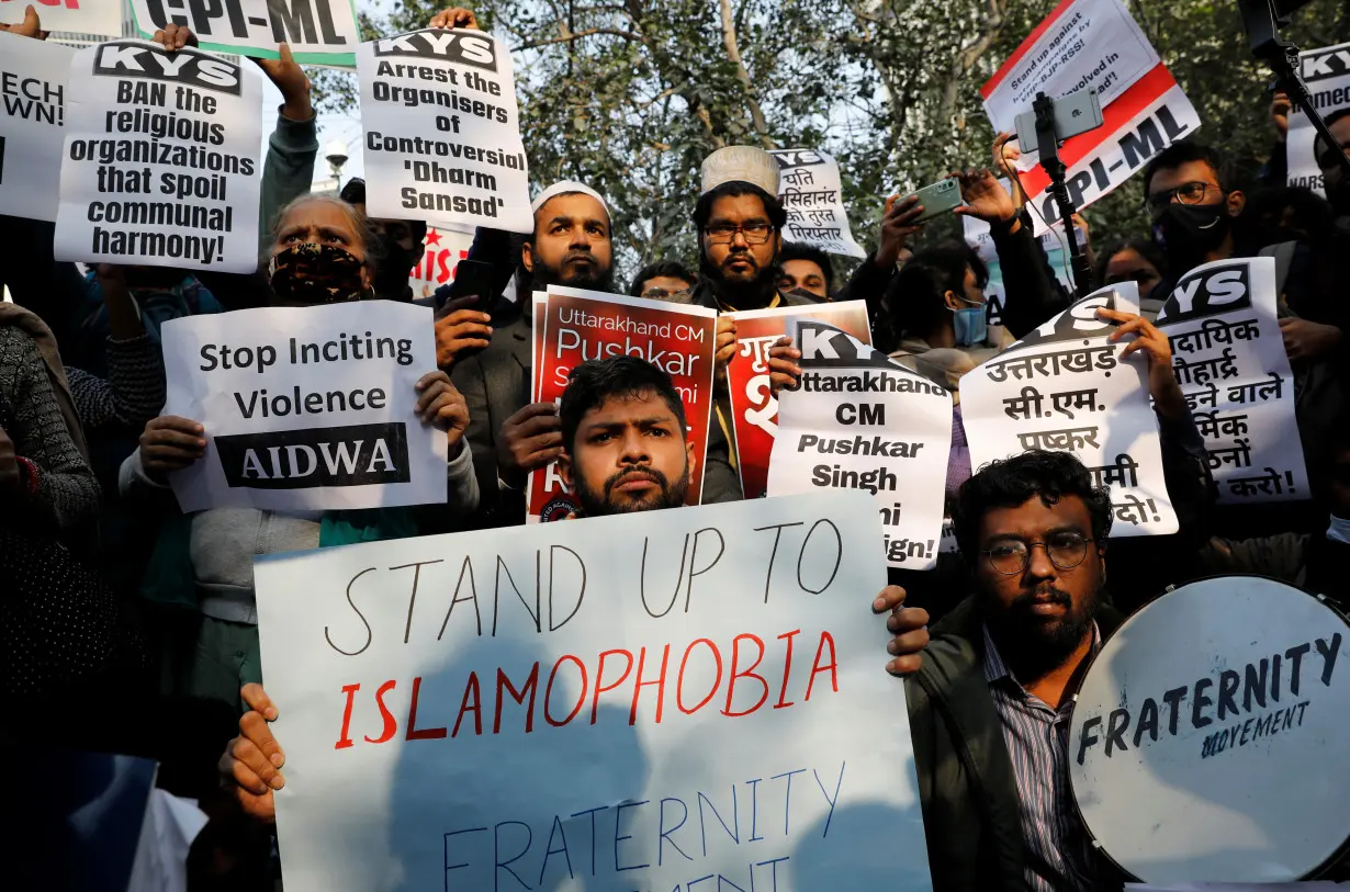 Demonstrators hold placards during a protest against what they say is hate speech against Muslims by Hindu leaders, in New Delhi