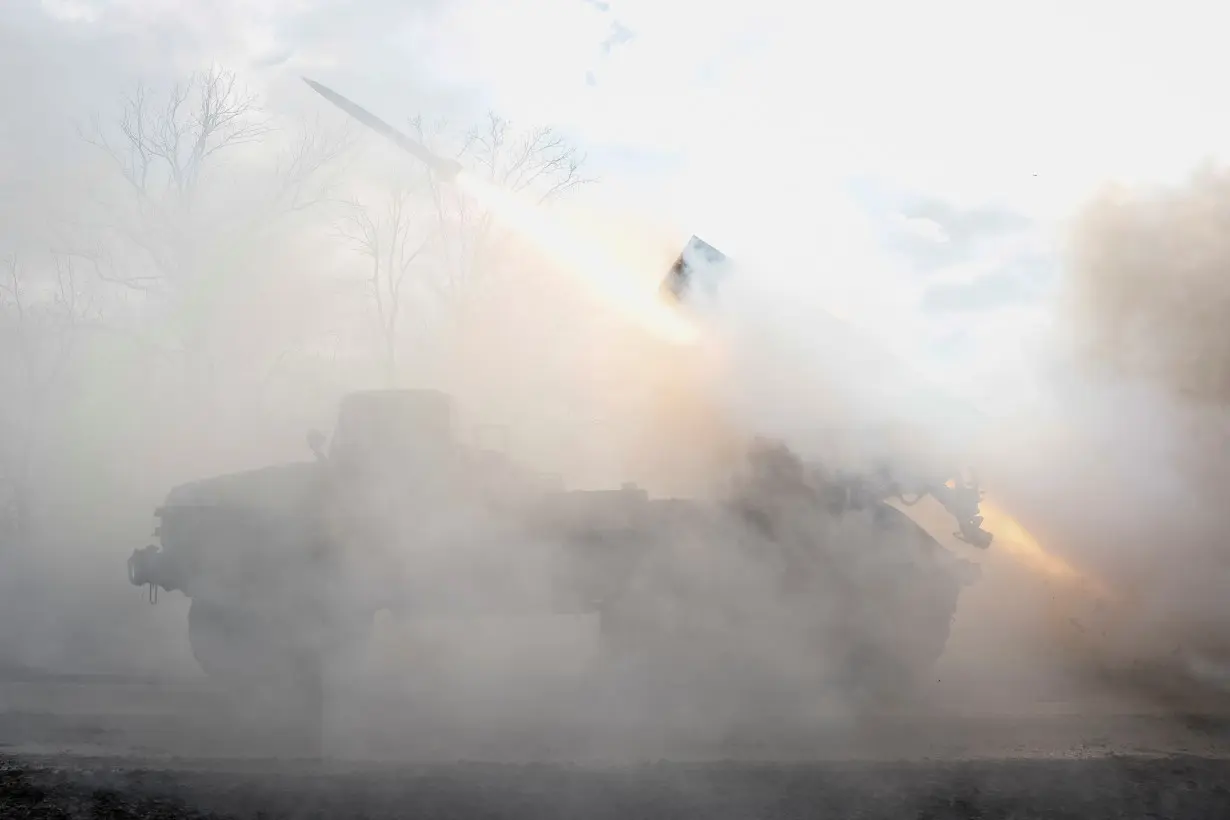 Ukrainian servicemen fire a BM-21 Grad multiple launch rocket system towards Russian troops in Donetsk region