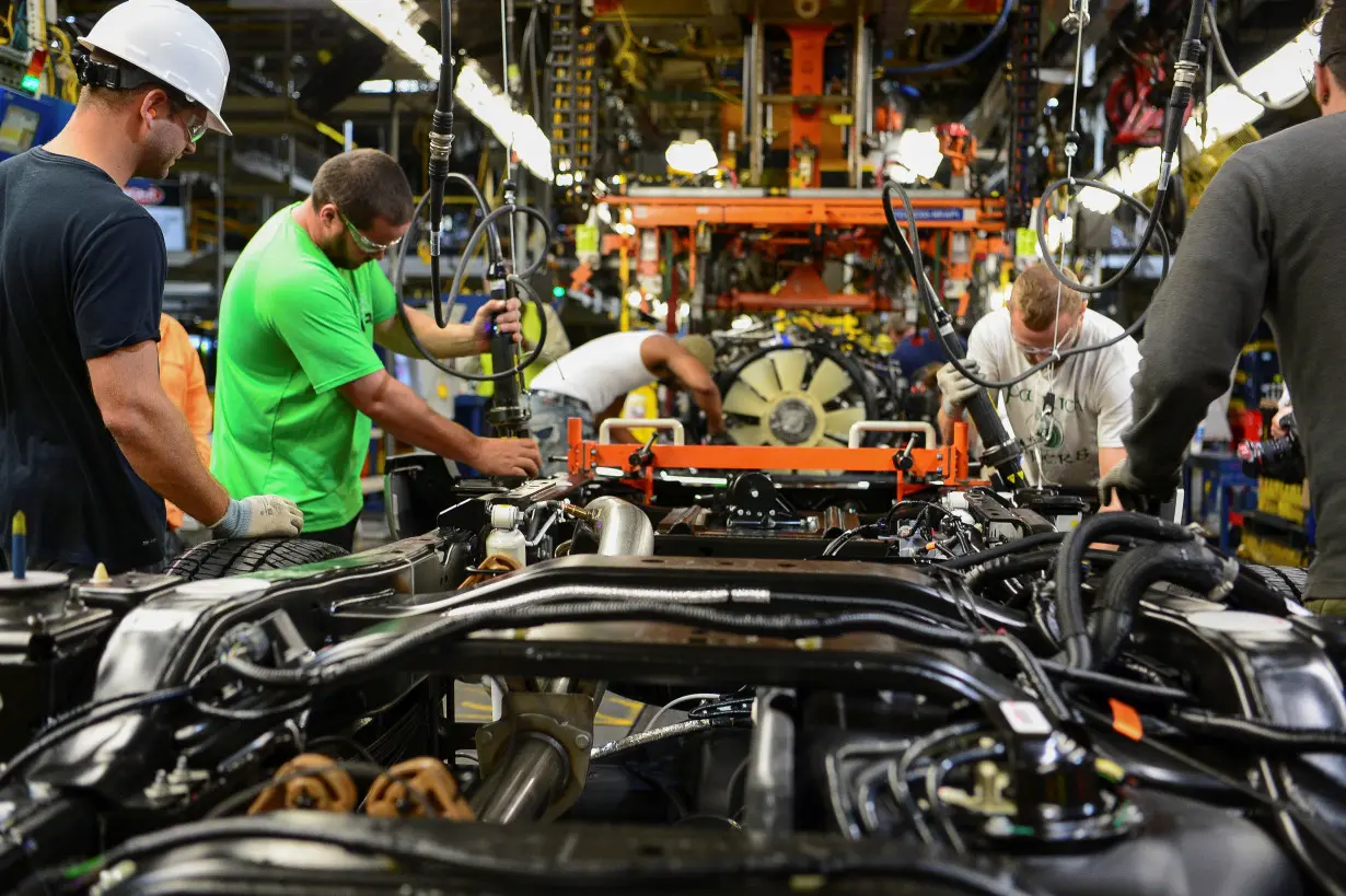 Workers assemble a Ford truck at the new Louisville Ford truck plant in Louisville