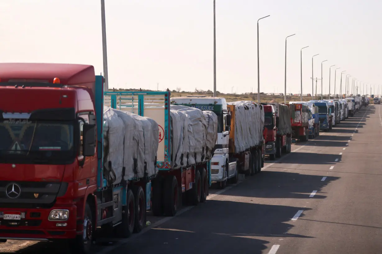 Trucks carrying aid line up near the Rafah border crossing between Egypt and the Gaza Strip