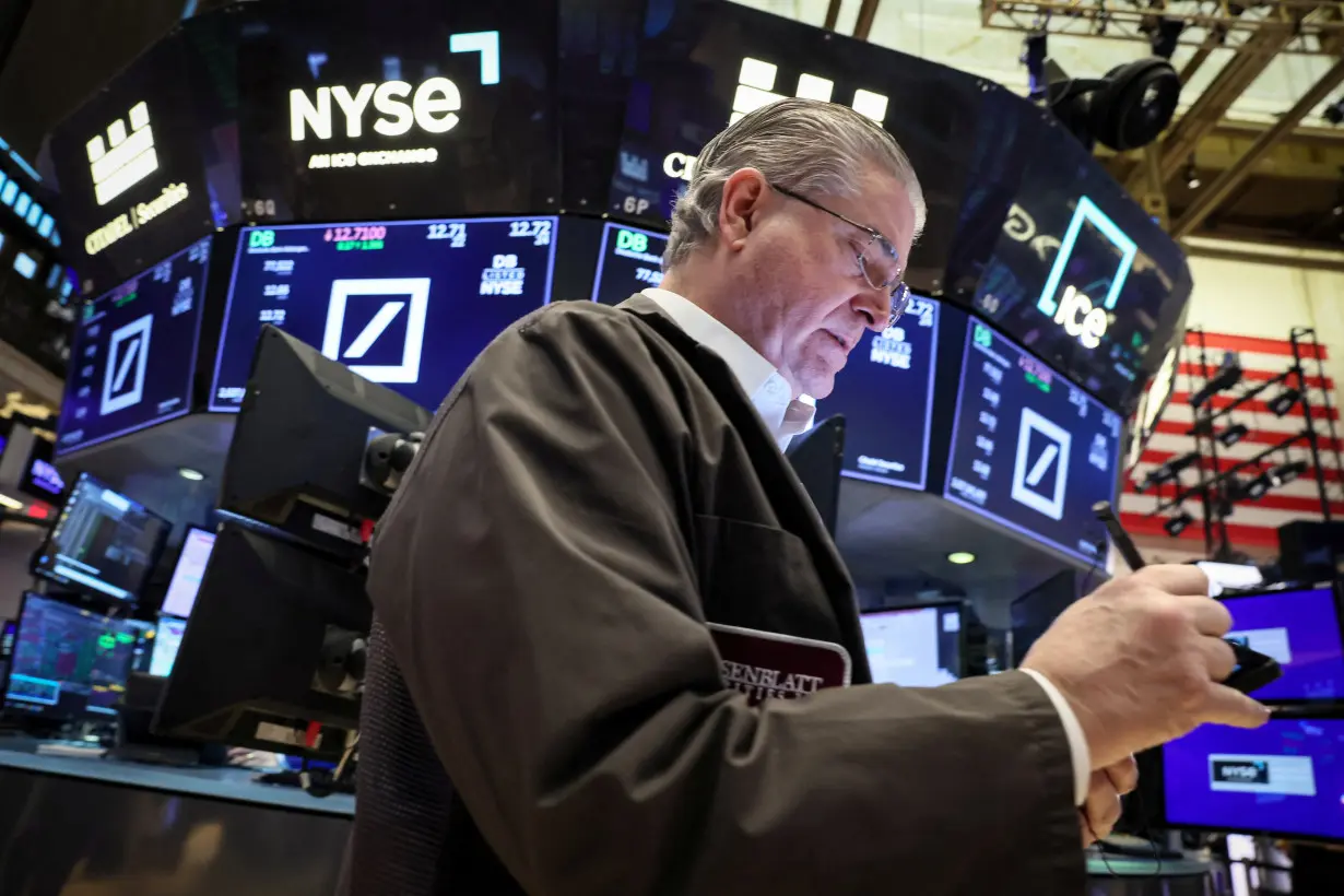 Traders work on the floor of the NYSE in New York