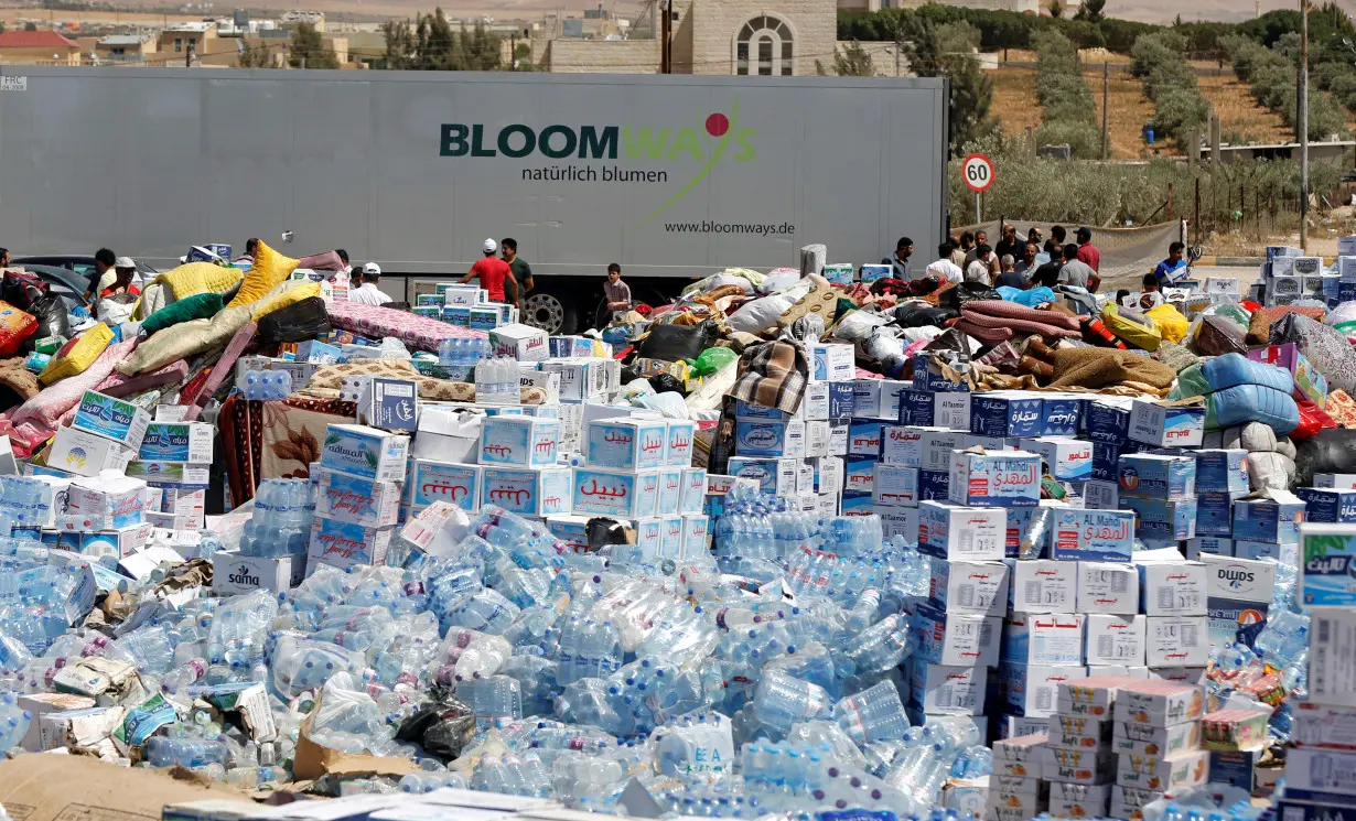 FILE PHOTO: Humanitarian aid is prepared to be delivered to Syria, in the town of Ramtha