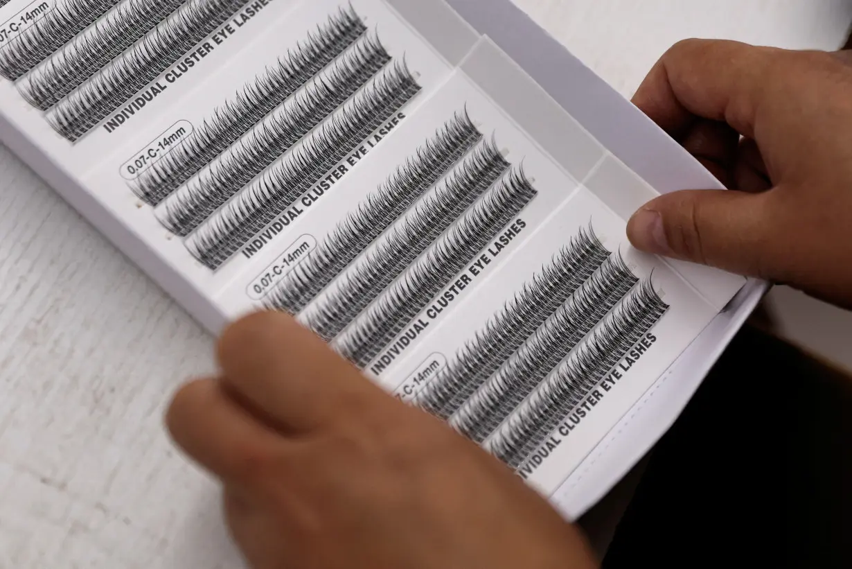 Worker works on a production line manufacturing false eyelashes at a workshop of Monsheery, in Pingdu