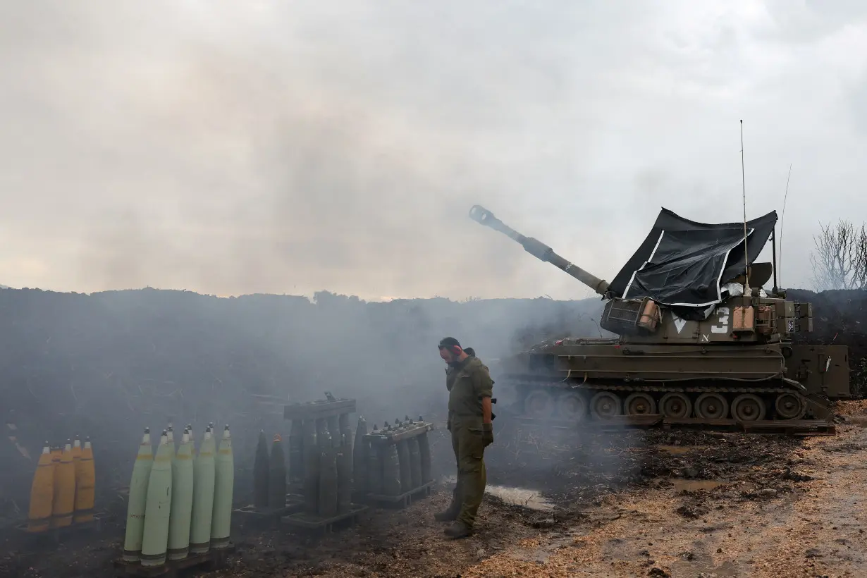 Israeli soldiers stand by near the Israel-Lebanon border