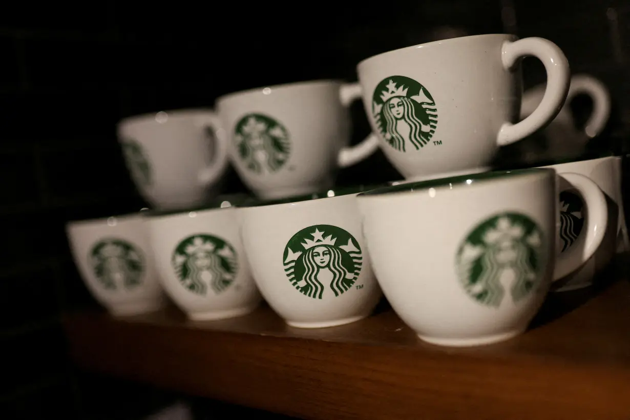 FILE PHOTO: Branded coffee mugs are displayed in Starbucks' outlet at a market in New Delhi