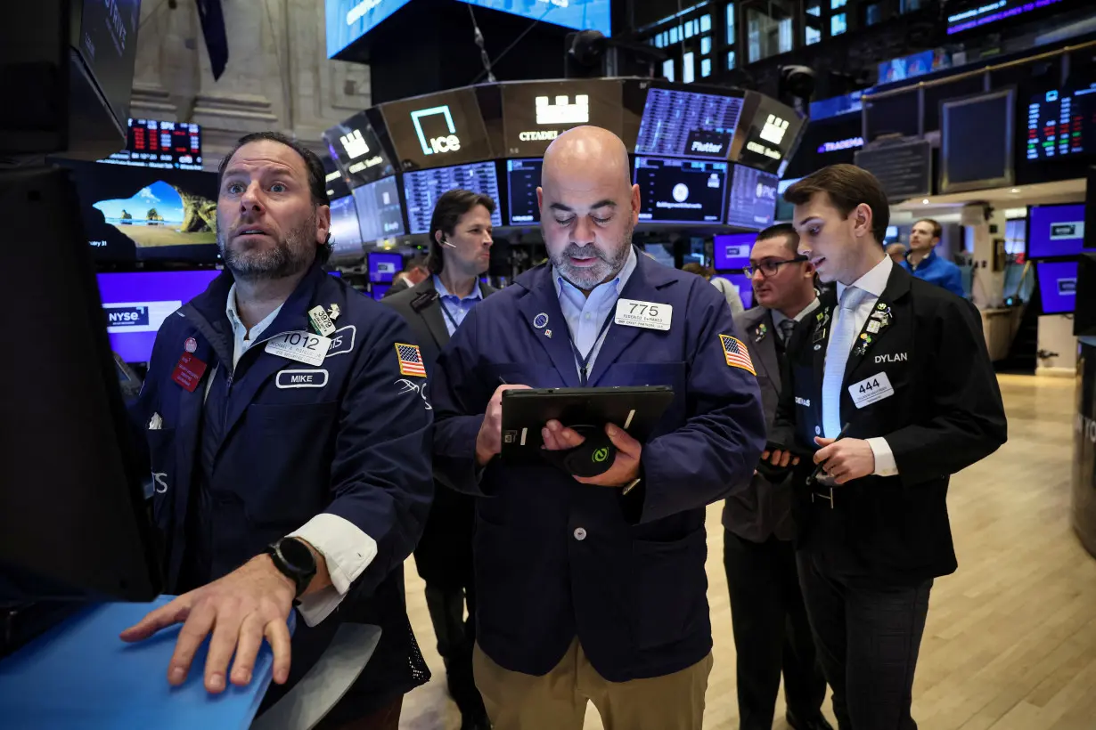 Traders work on the floor of the NYSE in New York