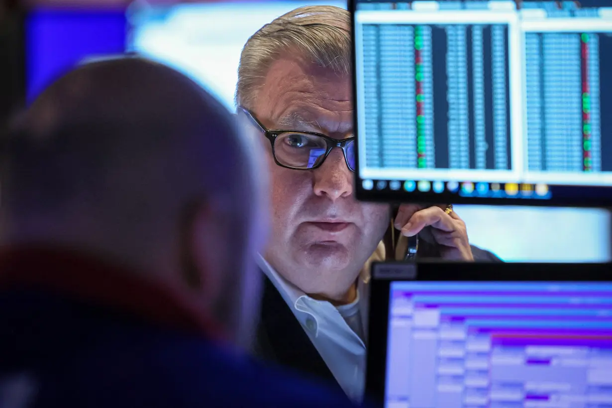 Traders work on the floor of the NYSE in New York