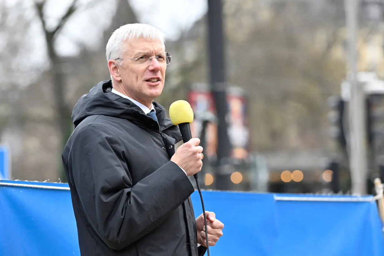 Latvian Foreign Minister Krisjanis Karins speaks at a rally in support of Ukraine at Norrmalmstorg in Stockholm