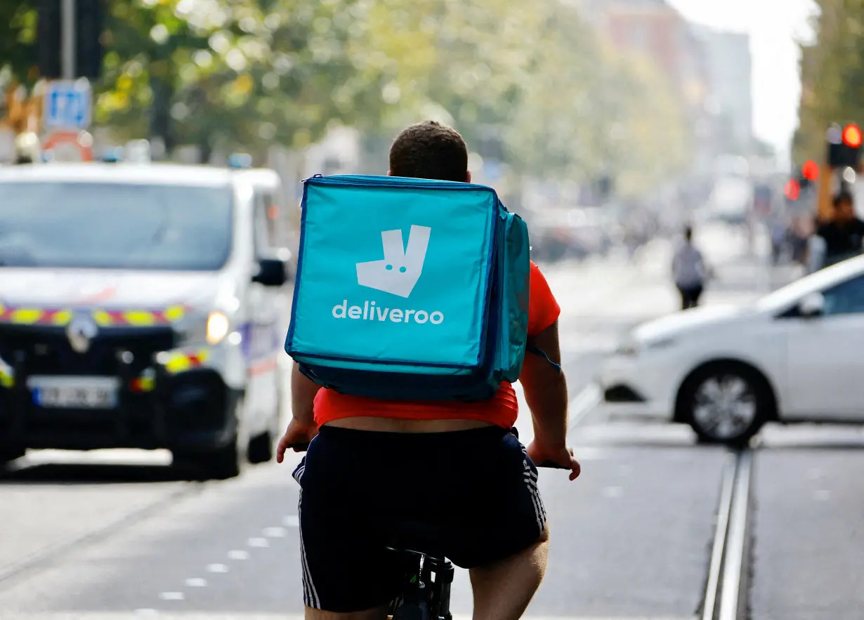 FILE PHOTO: A delivery worker rides a bike in Nice, France