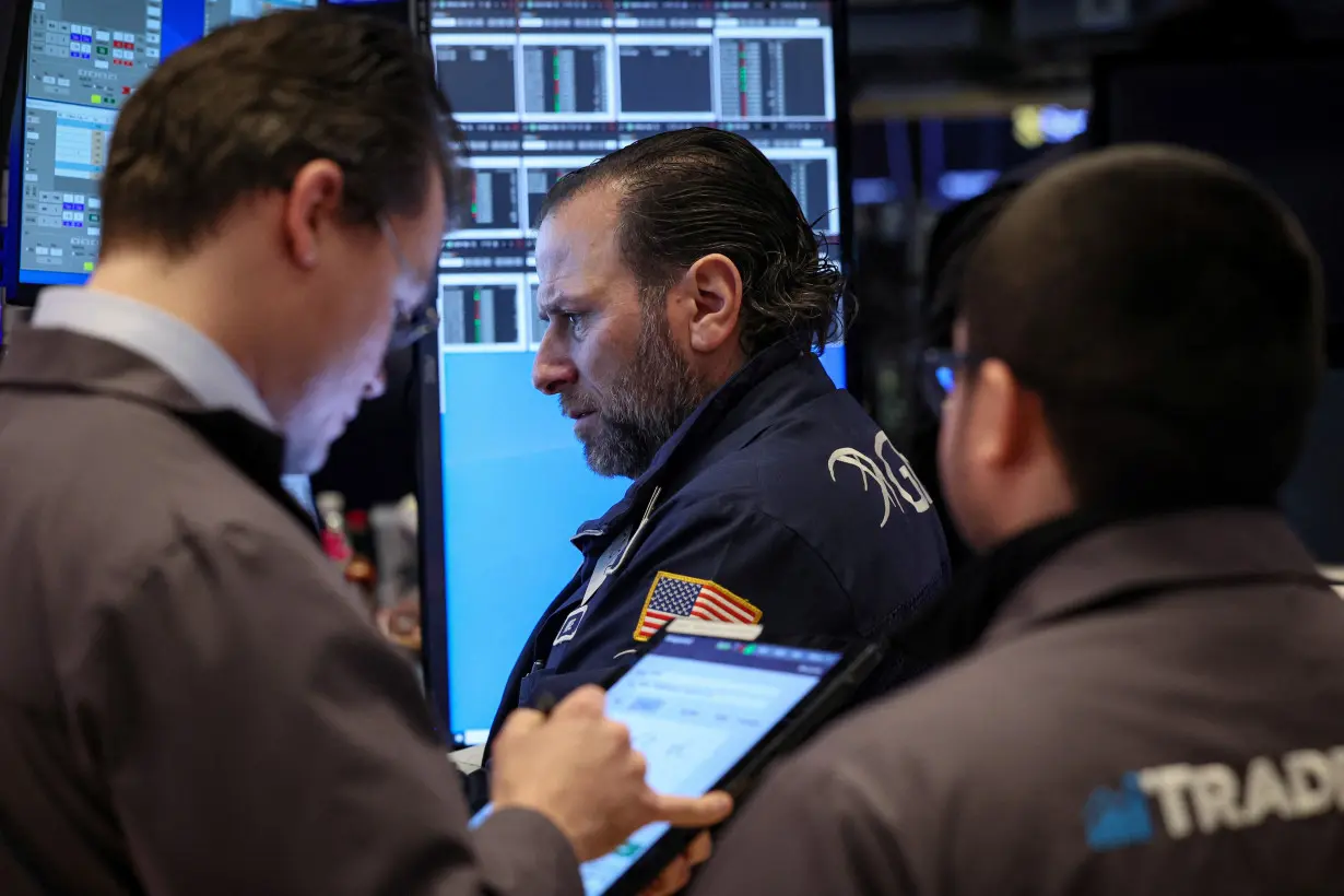 Traders work on the floor of the NYSE in New York