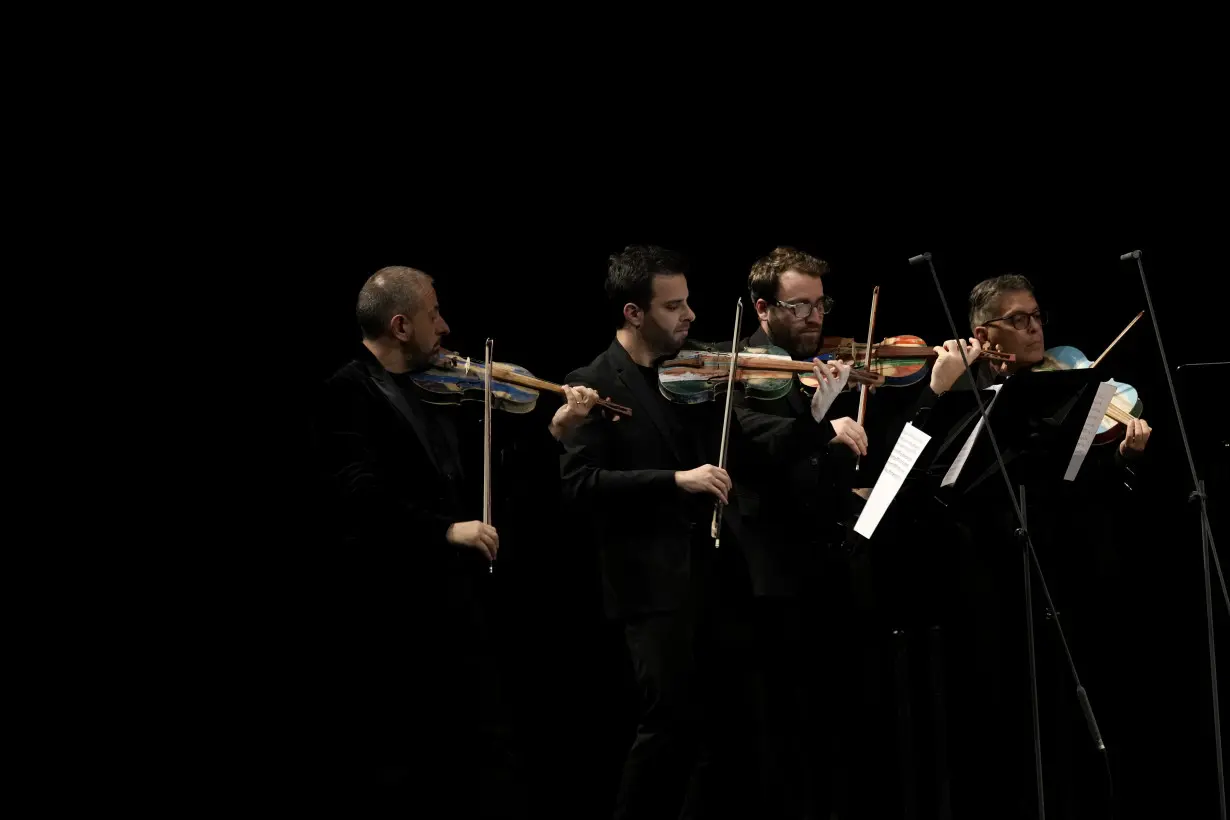 Italian inmates attend La Scala concert featuring violins they made from smugglers' boats