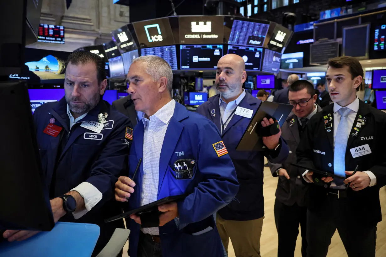 Traders work on the floor of the NYSE in New York