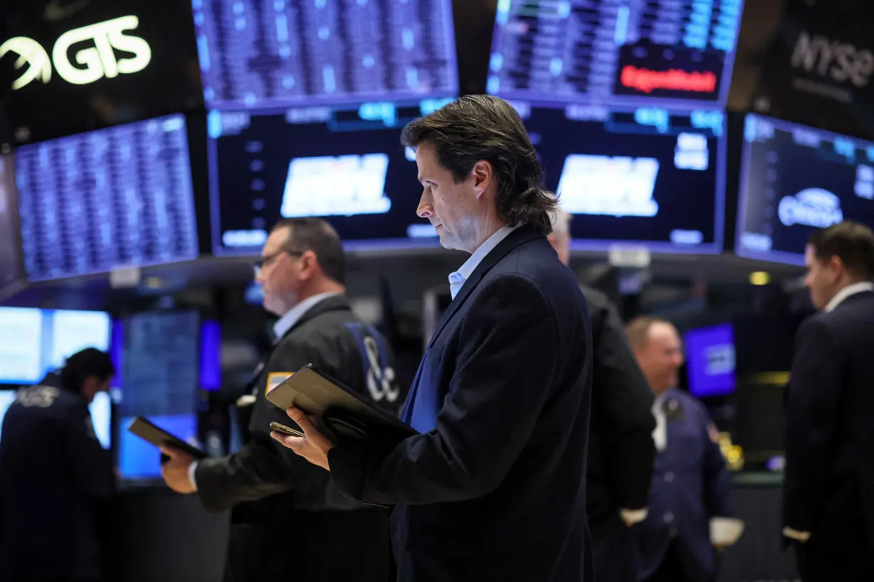 Traders work on the floor of the NYSE in New York