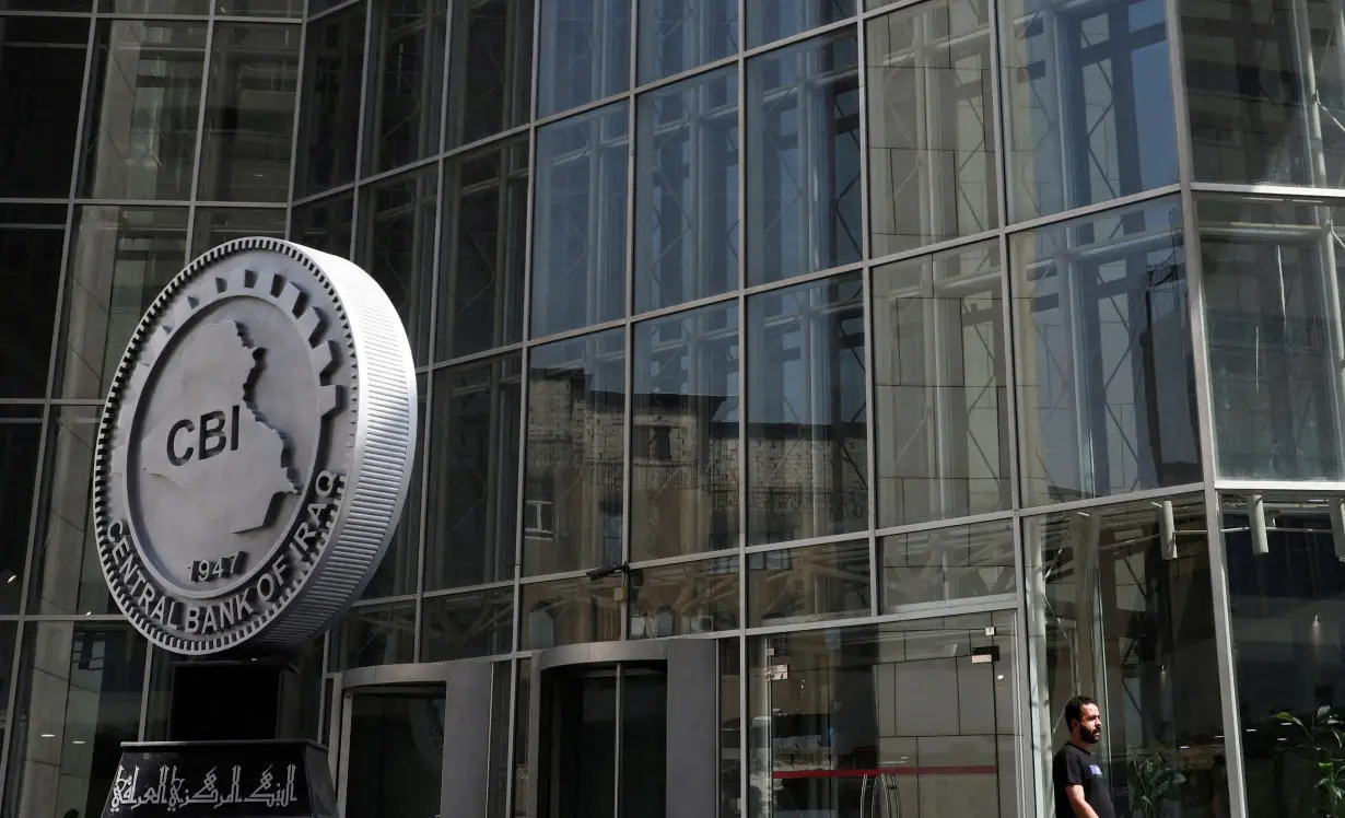 FILE PHOTO: FILE PHOTO: An Iraqi man walks at the headquarters of the Central Bank of Iraq in Baghdad