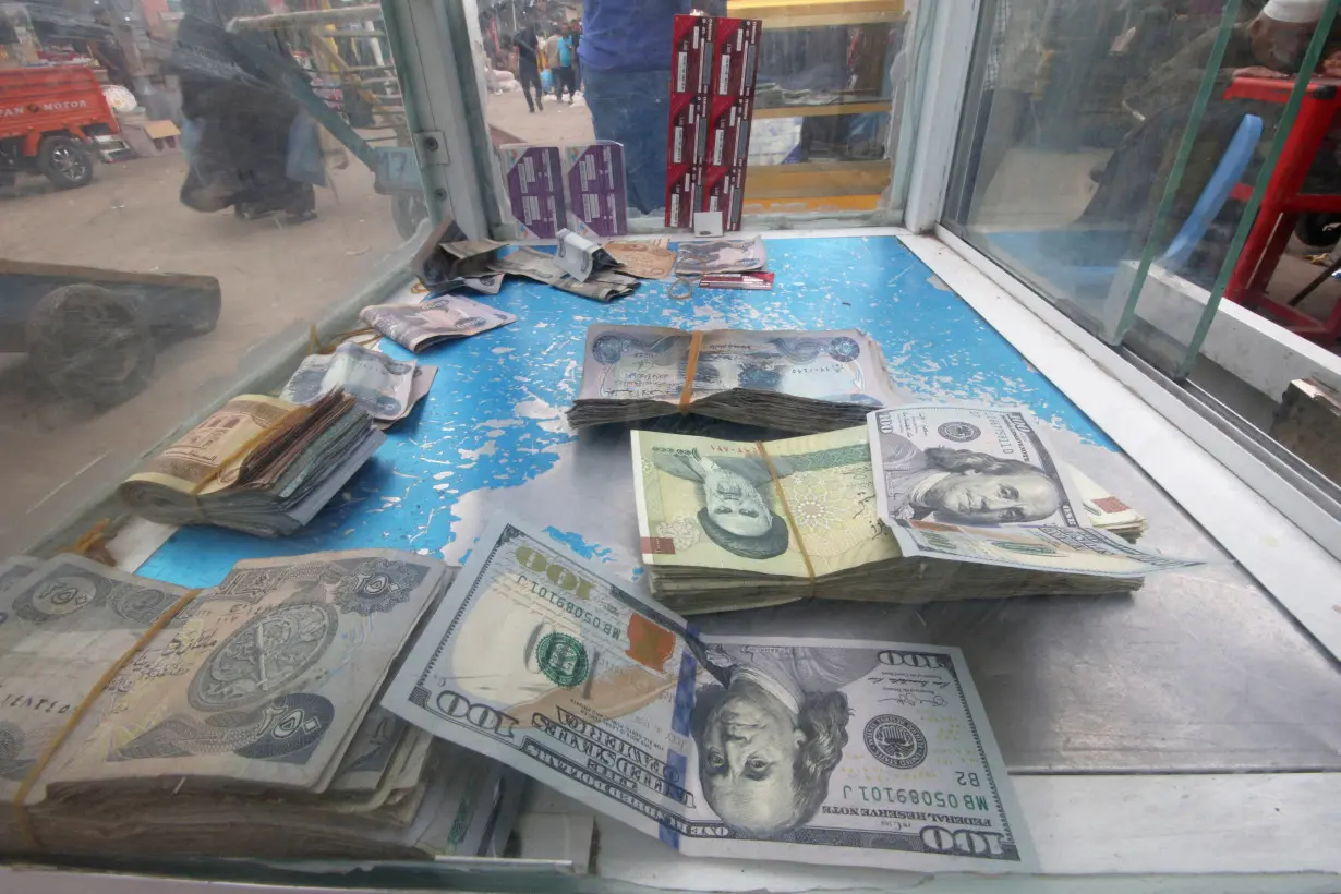 FILE PHOTO: Iranian rials, U.S. dollars and Iraqi dinars are seen at a currency exchange shopÊin Basra