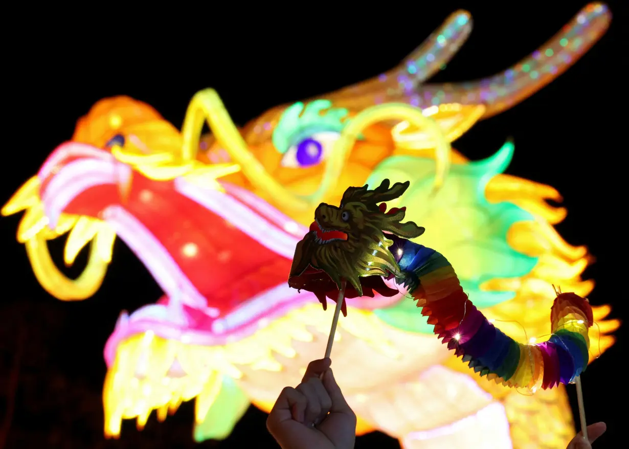 FILE PHOTO: A performer holds a replica of dragon during a show ahead of the Chinese Lunar New Year celebration at Jenjarom