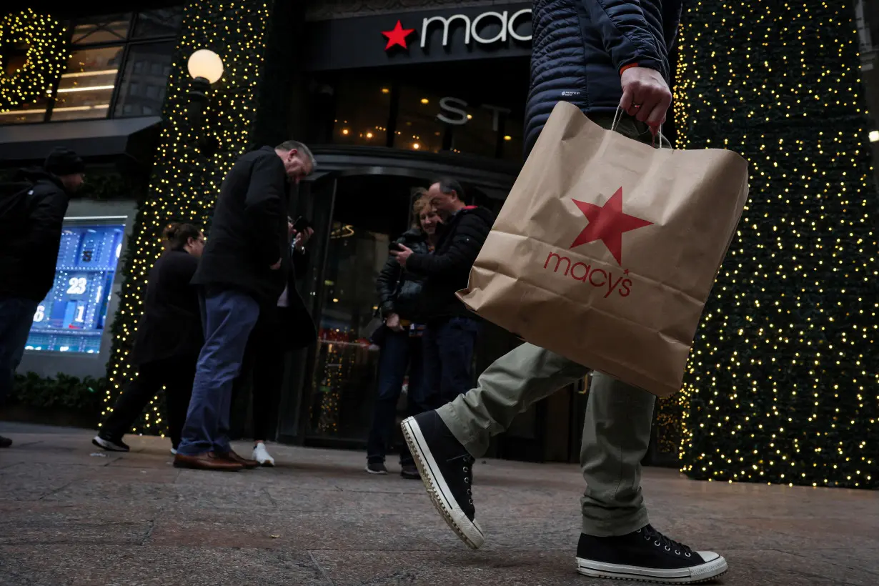 A customer exits the Macy's flagship department store in midtown Manhattan in New York