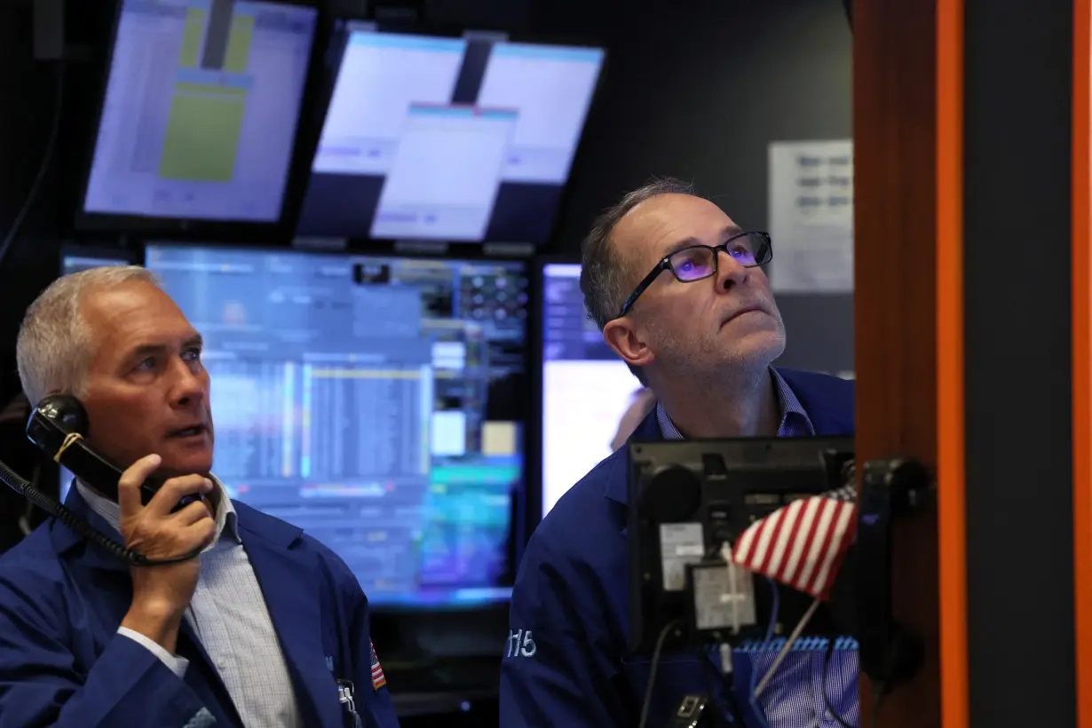 Traders work on the floor of the NYSE in New York