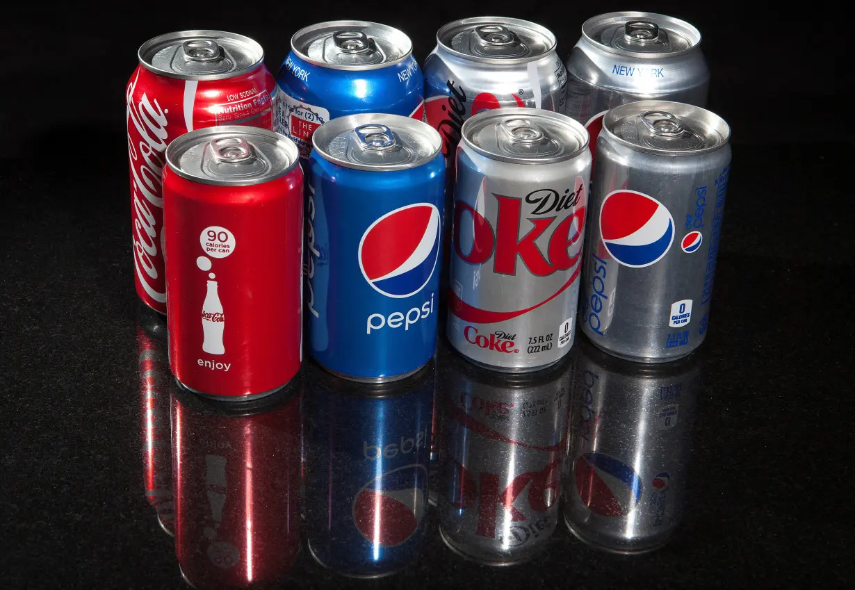 FILE PHOTO: Regular and mini cans of Coke and Pepsi are pictured in this photo illustration in New York