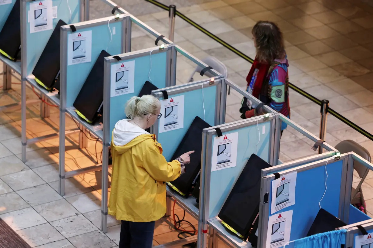 A voter casts her ballot in the state's Democratic and Republican presidential primary election, in Las Vegas