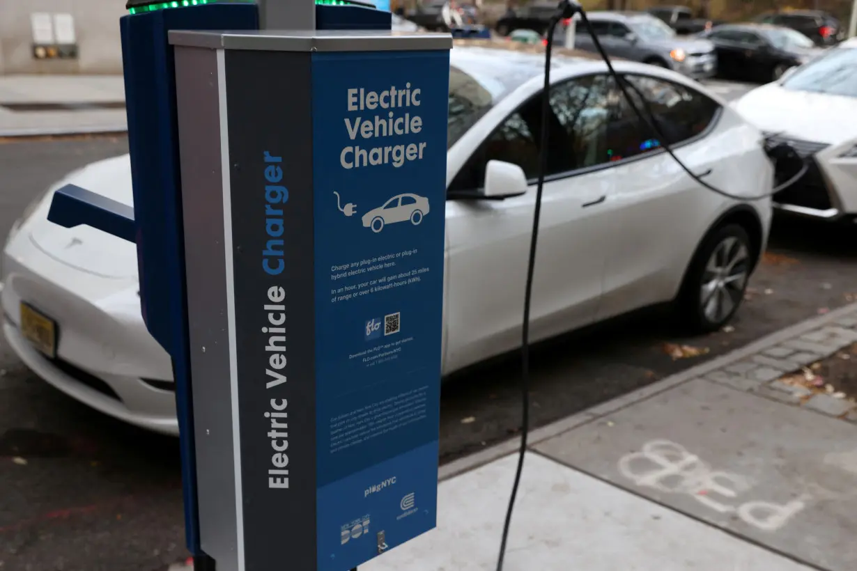 FILE PHOTO: A electric vehicle charger is seen as a vehicle charges in Manhattan, New York