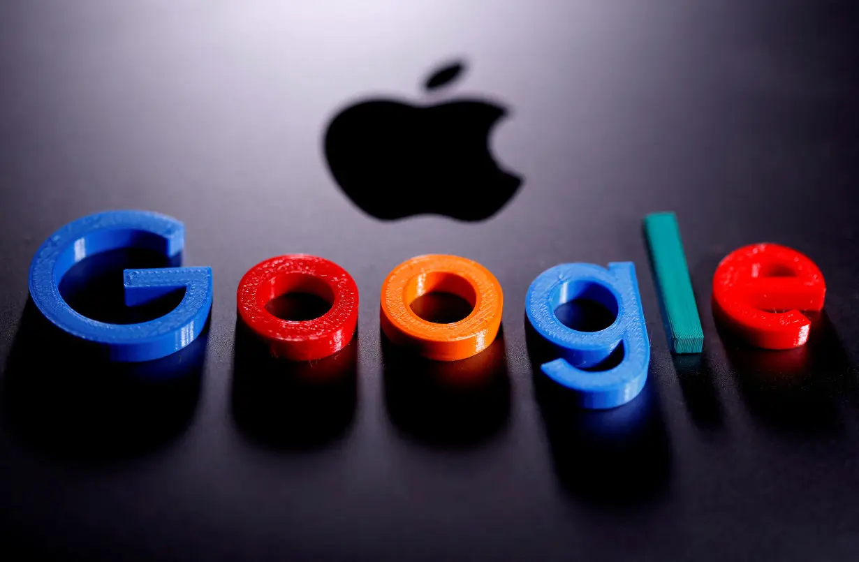 FILE PHOTO: FILE PHOTO: A 3D printed Google logo is placed on the Apple Macbook in this illustration