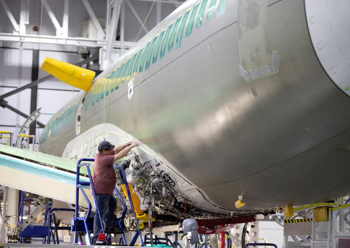 FILE PHOTO: An employee works on an Airbus A220-300 at their facility in Mirabel