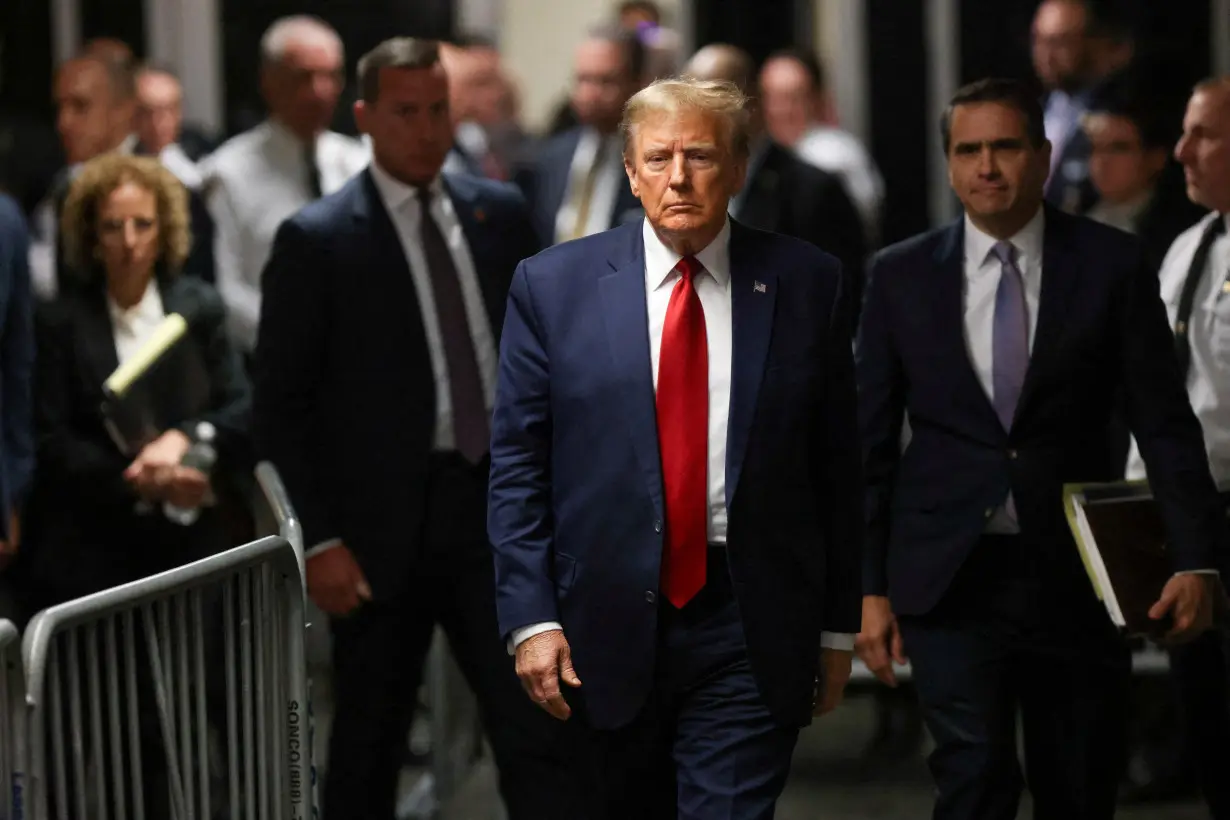 FILE PHOTO: Former U.S. President Trump attends a hearing on a criminal case linked to a hush money payment, in New York City