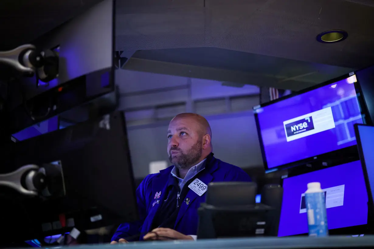 Traders work on the floor of the NYSE in New York